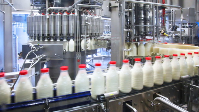 milk poured into bottles, screwed caps and send to consumers