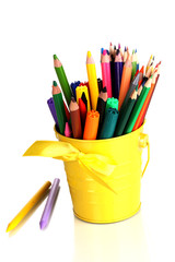 Colorful pencils and felt-tip pens in yellow pail isolated