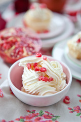 Little cakes with cream and pomegranate