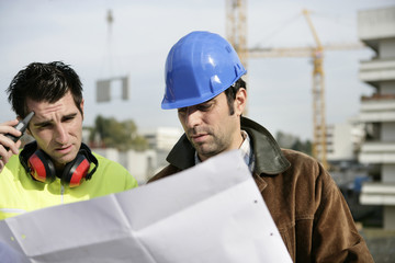 Foreman and colleagues examining building plans