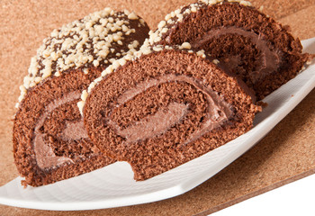 Swiss Sponge Roll With Cream on White Plate