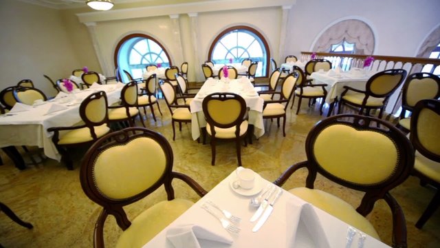 Many chairs and tables in empty restaurant