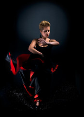 Portrait of beautiful young woman dancing flamenco splashing wat
