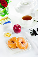 continental breakfast of  doughnut pastry and tea