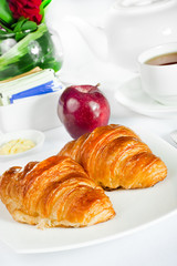 continental breakfast of croissant pastry and tea