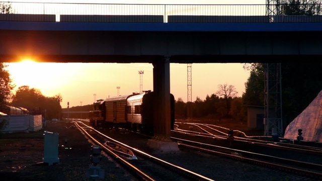 Train ride under bridge with car passes by