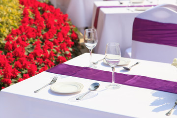 outdoor tables with served plate and wine glasses