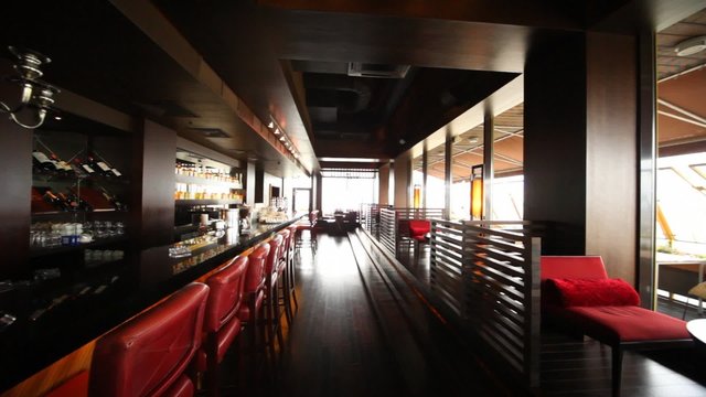 Chairs near to bar and tables for two stand in restaurant