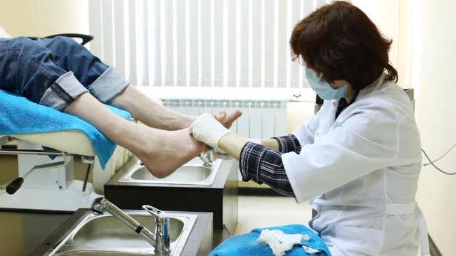 Cosmetician grinds man heel on doing pedicure in beauty salon