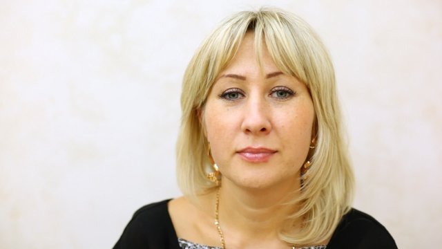 woman-blonde affably smiles on wight background