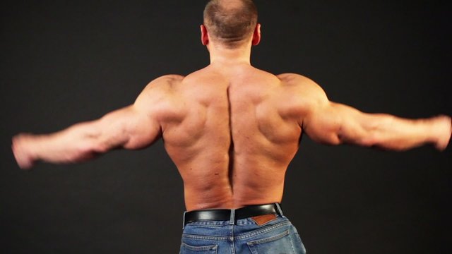 Bodybuilder shows muscular body