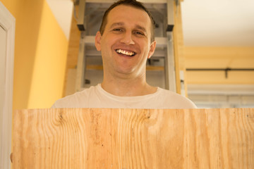 Handyman lifting plywood