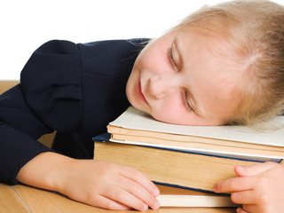 Girl asleep on the books.