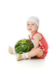 Fototapeta premium An adorable baby happily plays the watermelon