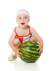 Fototapeta premium An adorable baby happily plays the watermelon