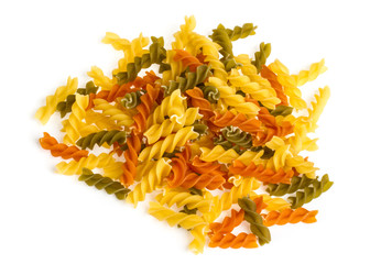 Uncooked pasta fusilli in different colours, white background