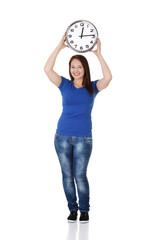 Happy young woman holding office clock