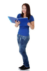 Studying thoughtful young woman reading her notebook