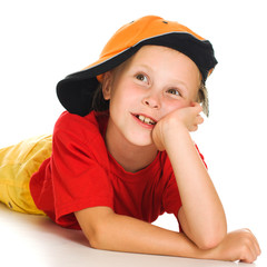 A cheerful little child with funny cap is lying
