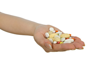 Hands holding pills on white