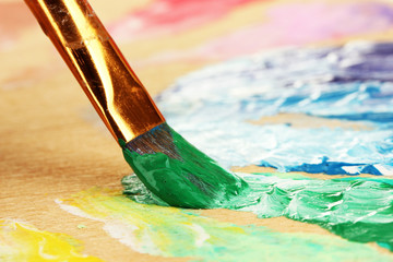 Abstract gouache paint and brush on wooden palette