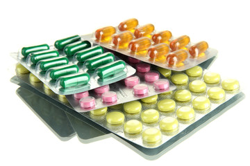 Capsules and pills packed in blisters, isolated on white