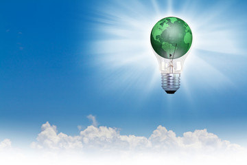 Green earth in bulb over blue sky