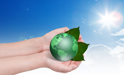 Eco concept : Earth in hands over blue sky