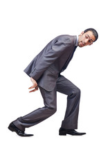 Young businessman pushing invisible obstacles