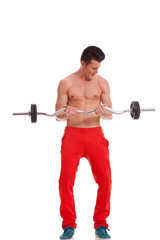 Ripped young man lifting a barbell