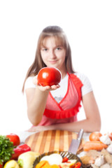 girl the cook offers a tomato