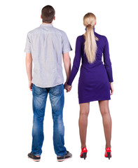 Back view of young embracing couple