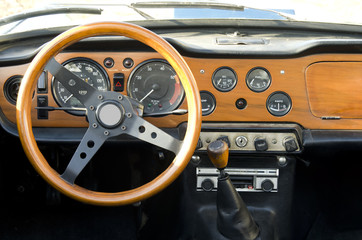 wooden dashboard of a vintage car - 44674723