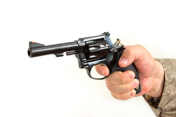 masculine hand holds a black pistol