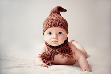 newborn baby in a cap and scarf