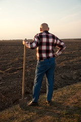 male farmer with spade  back