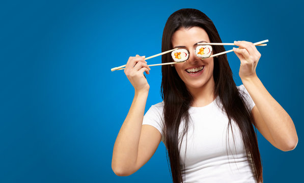 Portrait Of A Female Holding Sushi Roll