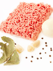 Minced meat with spices and garlic on white background