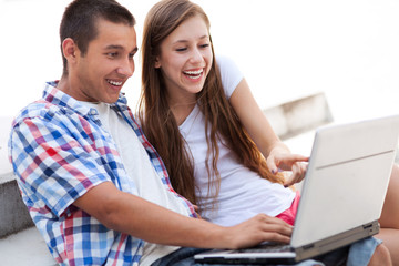 Couple looking at laptop together