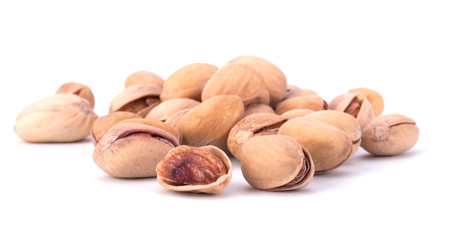 Toasted pistachios closeup on white background