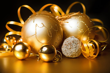 gold christmas balls with black background