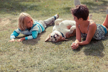 Fototapeta premium Two Children Playing with the Dog