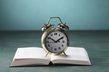 alarm clock on open book