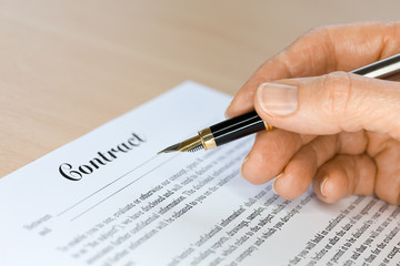 Hand with Fountain Pen Signing a Contract