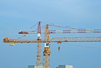 two tall steel crane at a construction site of construction