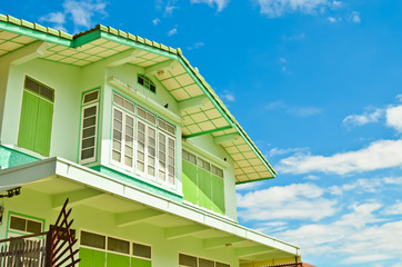Outside of a green house with blue sky
