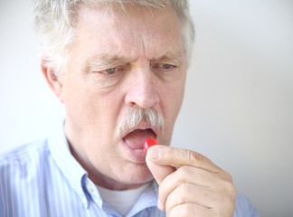 senior man with cough drop