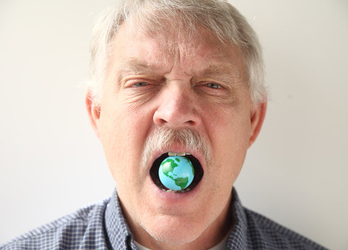 man with earth model in his mouth