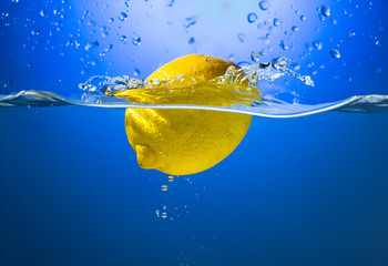 Yellow lemon in water splash