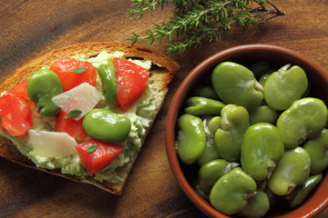 Broad beans in bowl and sandwich